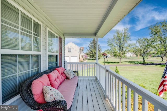 wooden deck featuring a yard and a porch