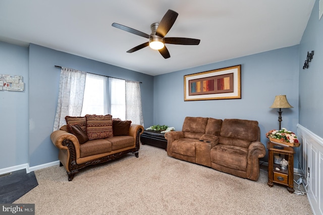 carpeted living room with ceiling fan