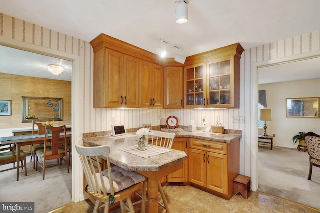 interior space featuring baseboards, light carpet, and wallpapered walls