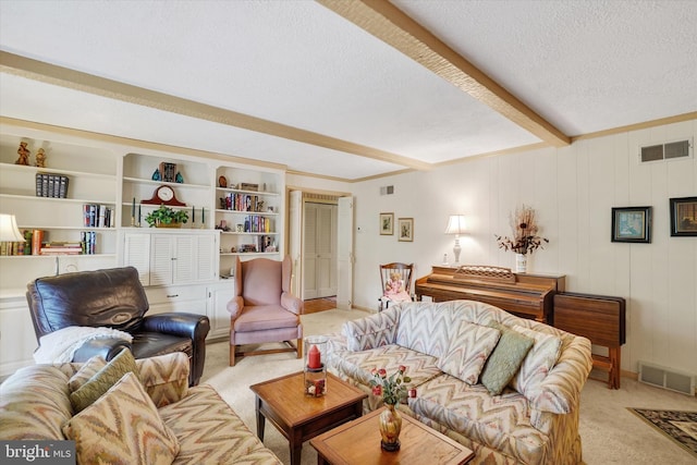 living room with beamed ceiling, light colored carpet, a textured ceiling, and visible vents