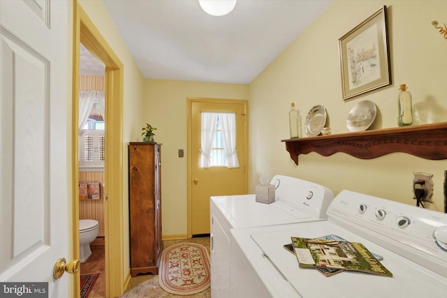 laundry room featuring washer and dryer, laundry area, plenty of natural light, and baseboards