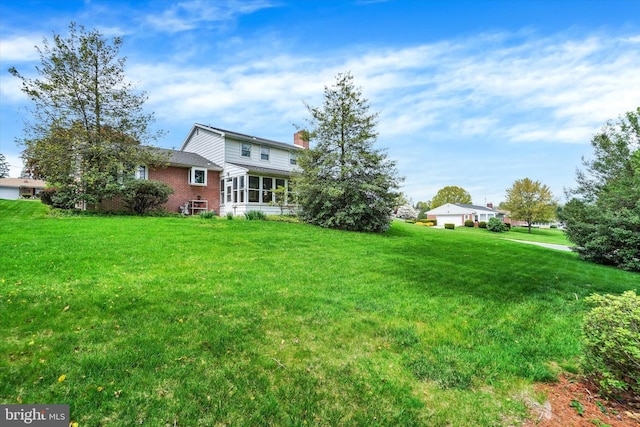 view of yard featuring a sunroom