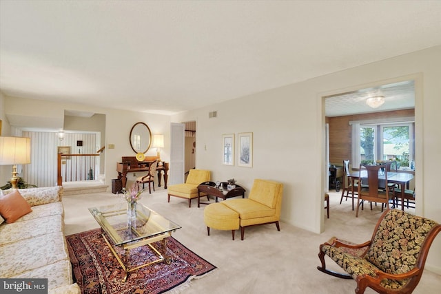 living area with light carpet and visible vents