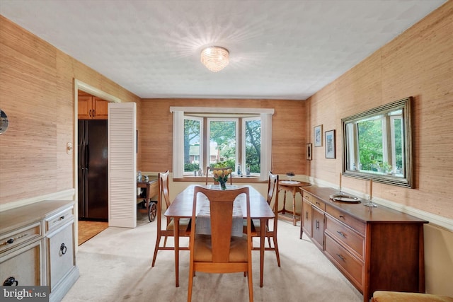 dining area featuring light colored carpet and a wealth of natural light