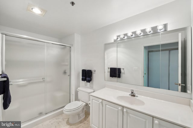 bathroom with toilet, a shower stall, and vanity