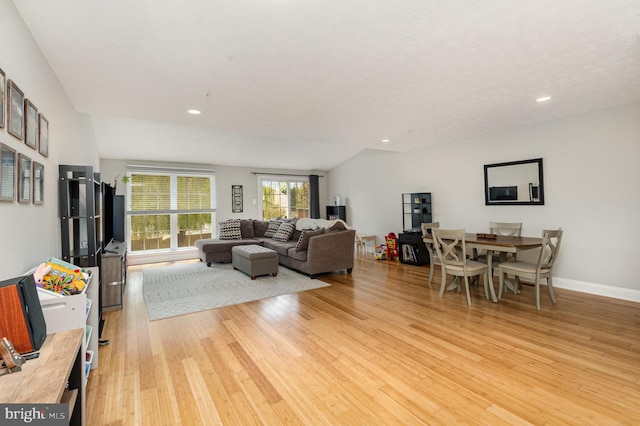 living room with recessed lighting, baseboards, and light wood-style floors