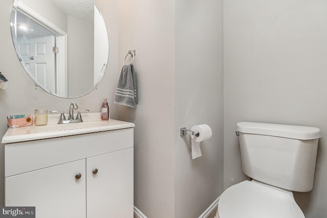 half bath with vanity and toilet