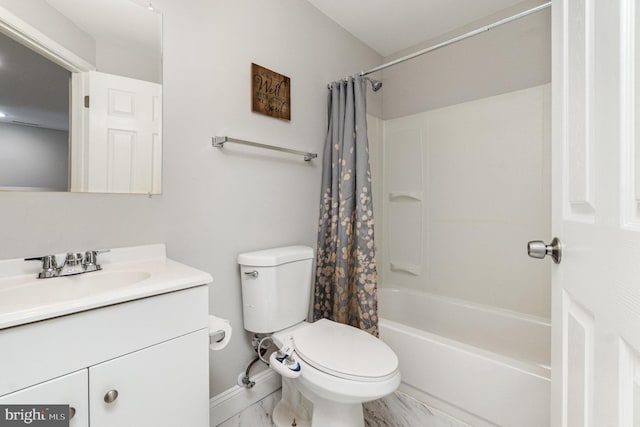full bath featuring vanity, baseboards, toilet, marble finish floor, and shower / bath combo with shower curtain
