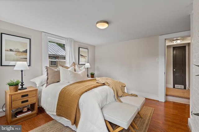 bedroom featuring wood finished floors and baseboards