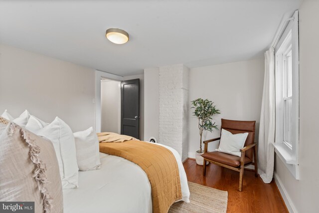 bedroom featuring wood finished floors and baseboards