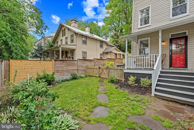 view of yard featuring a porch and fence