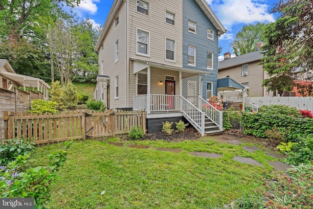 view of front of house with a porch and a gate