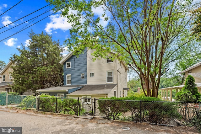 view of front facade with a fenced front yard and a gate