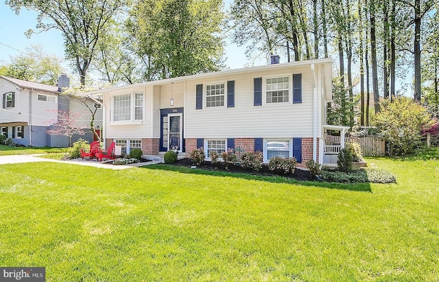 raised ranch with a front yard