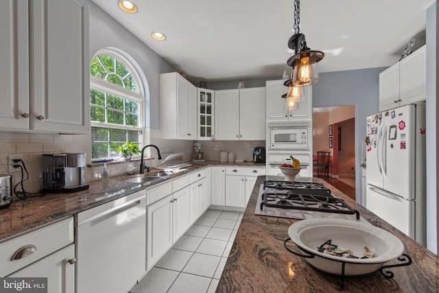 36 Crimson King Dr, Bear, DE 19701 - kitchen with white appliances, glass insert cabinets, a sink, dark stone countertops, and light tile patterned floors