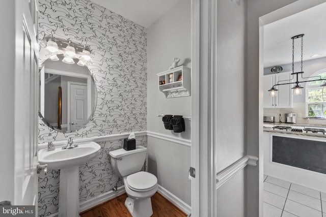 36 Crimson King Dr, Bear, DE 19701 - half bath featuring wood finished floors, an accent wall, toilet, and wallpapered walls