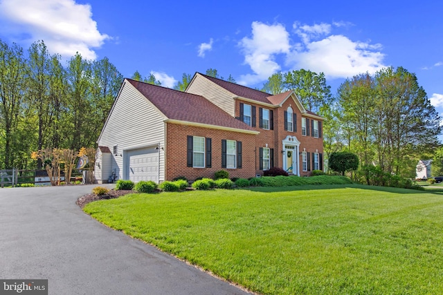 36 Crimson King Dr, Bear, DE 19701 - colonial house featuring brick siding, a garage, driveway, and a front yard