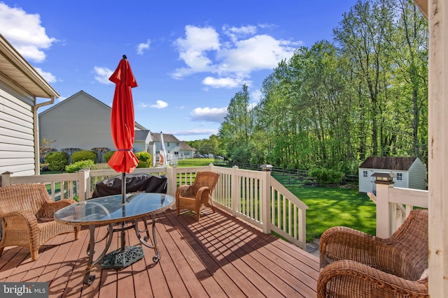 36 Crimson King Dr, Bear, DE 19701 - wooden deck featuring outdoor dining area, a fenced backyard, a shed, a yard, and an outbuilding