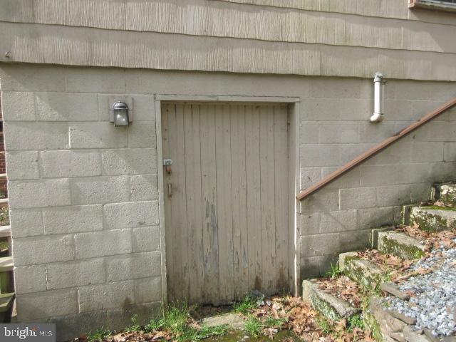 entrance to property featuring concrete block siding
