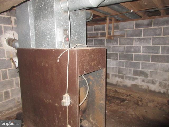 utility room featuring heating unit