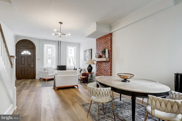 615 1st St, Lancaster, PA 17603 - dining space with ornamental molding, light wood-style flooring, a chandelier, and stairway