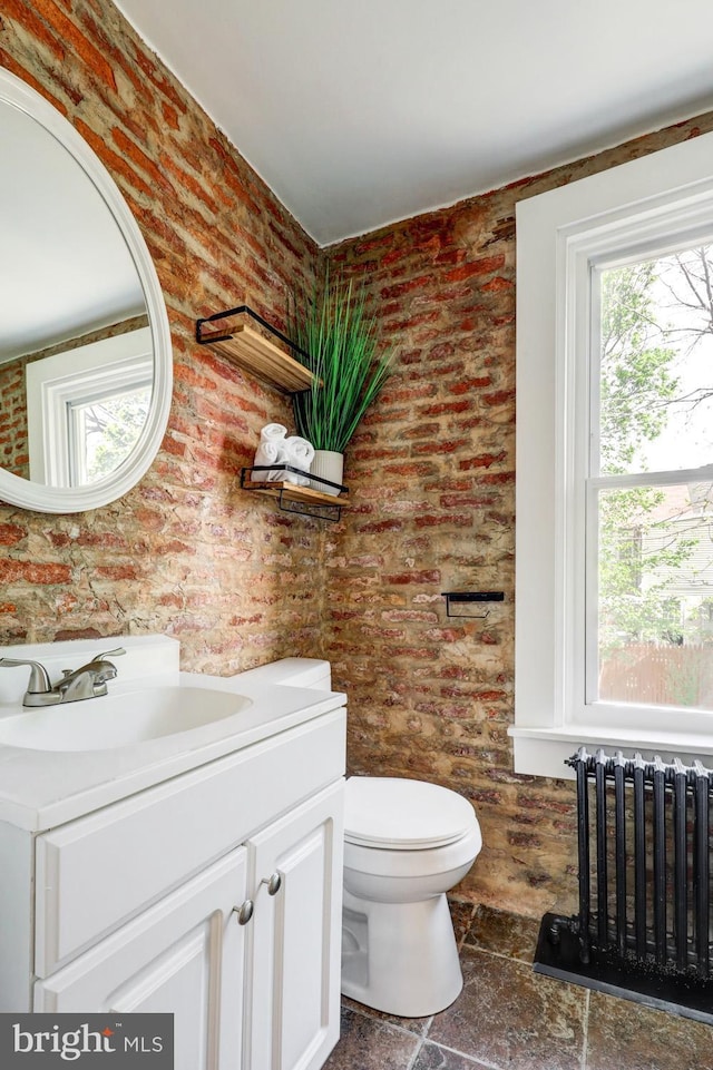 615 1st St, Lancaster, PA 17603 - half bath featuring radiator, plenty of natural light, toilet, and brick wall