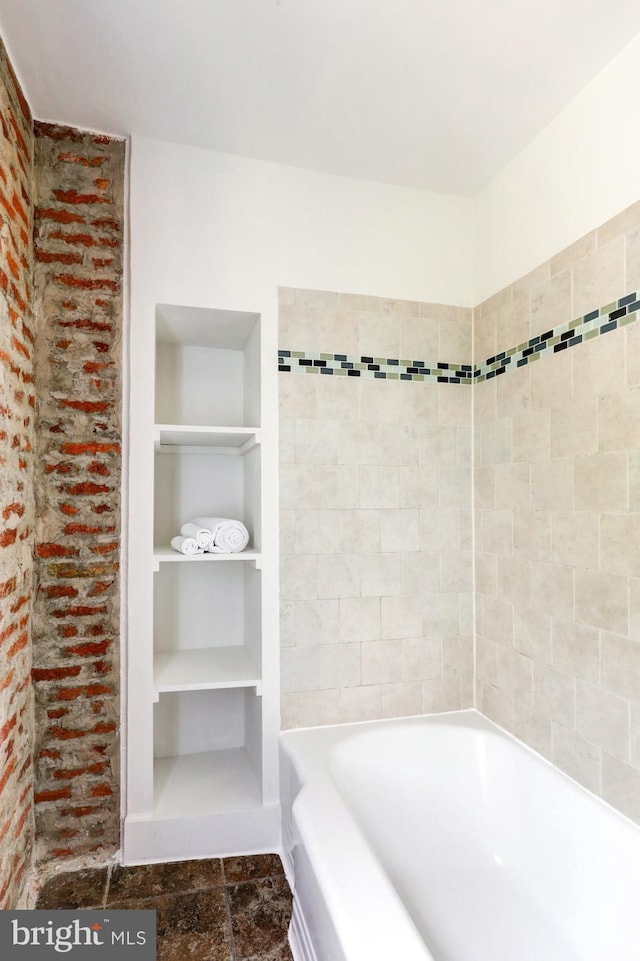 615 1st St, Lancaster, PA 17603 - bathroom featuring built in features, stone finish flooring, and a bath