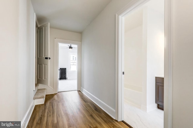 615 1st St, Lancaster, PA 17603 - corridor with baseboards, radiator heating unit, and wood finished floors