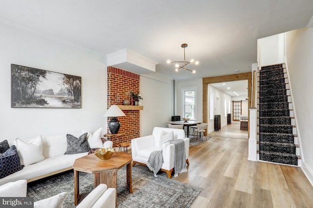 615 1st St, Lancaster, PA 17603 - living room featuring an inviting chandelier, light wood-style flooring, stairway, and a fireplace