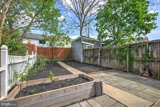 615 1st St, Lancaster, PA 17603 - view of yard featuring a fenced backyard, a patio, and a vegetable garden