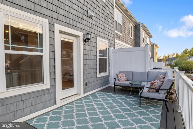 wooden deck with an outdoor living space