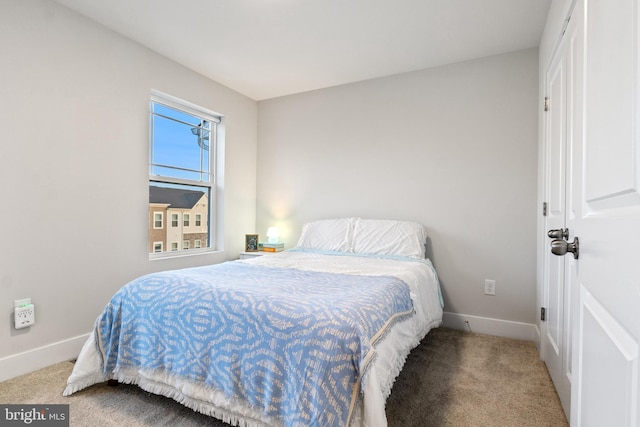 carpeted bedroom featuring baseboards