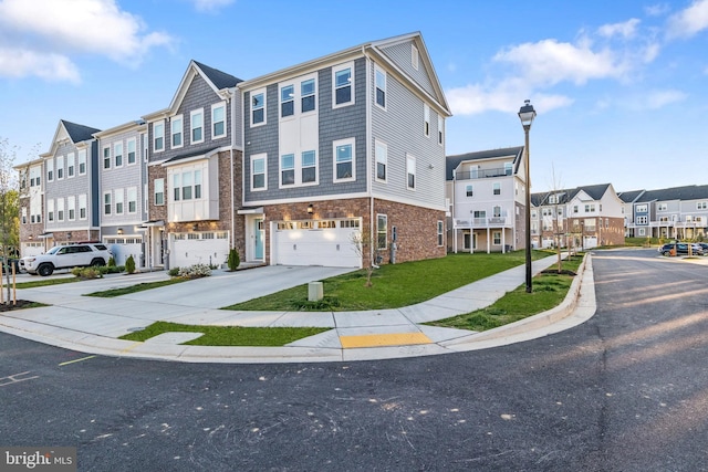 view of property featuring an attached garage, a front lawn, a residential view, and concrete driveway