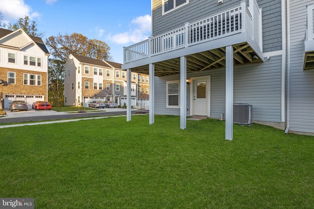 view of yard featuring central AC unit and a deck
