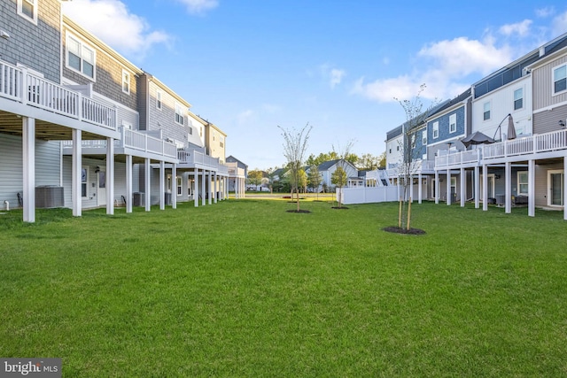view of yard featuring central air condition unit and a residential view