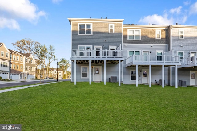 back of property featuring a yard, a residential view, and central air condition unit