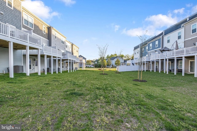 view of yard with central AC and a residential view