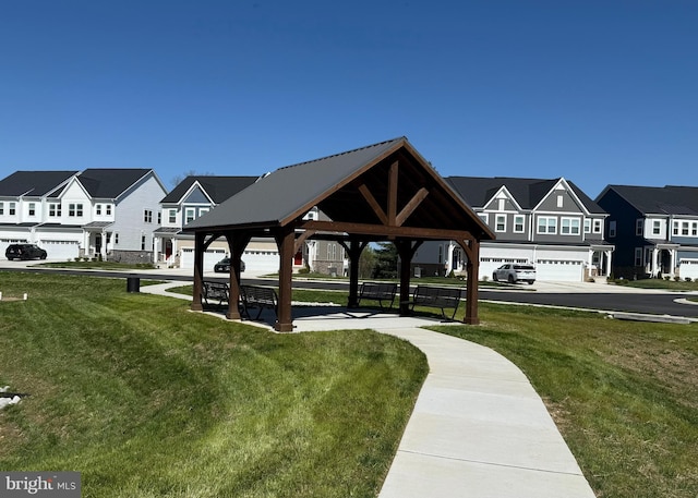 view of community with a yard, a gazebo, and a residential view