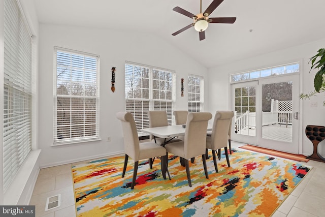 tiled dining room with ceiling fan, lofted ceiling, and visible vents