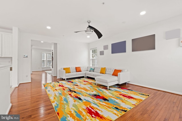 living area with a healthy amount of sunlight, recessed lighting, ceiling fan, and light wood finished floors