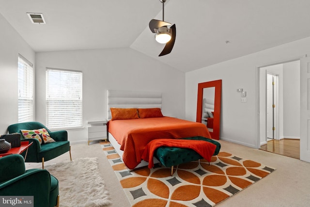 carpeted bedroom featuring baseboards, visible vents, ceiling fan, and vaulted ceiling
