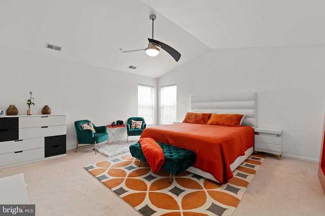 bedroom with carpet flooring, a ceiling fan, visible vents, and vaulted ceiling