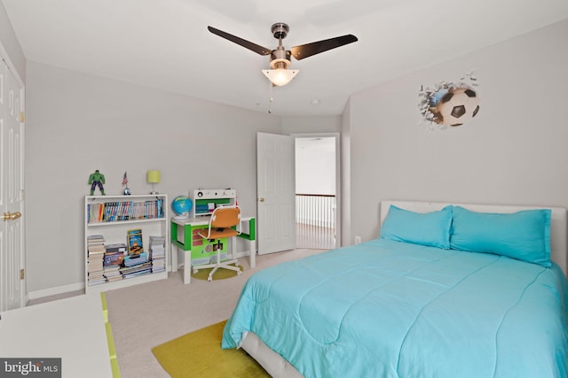 carpeted bedroom featuring baseboards and ceiling fan