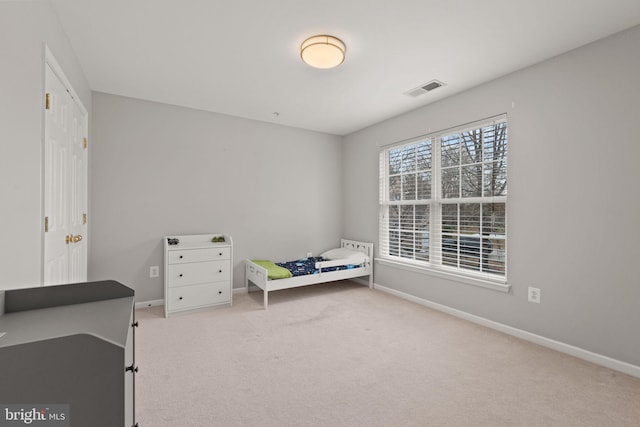 bedroom featuring baseboards, carpet floors, and visible vents