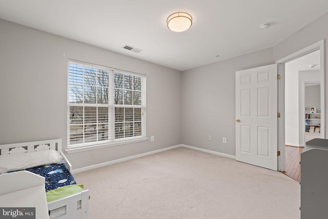 unfurnished bedroom with visible vents, baseboards, and carpet floors
