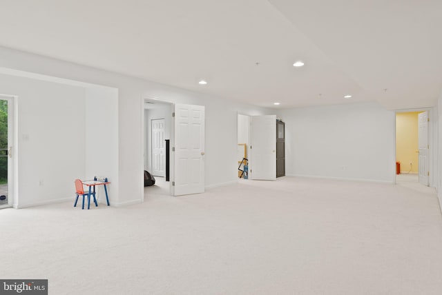 below grade area with recessed lighting, baseboards, and light colored carpet