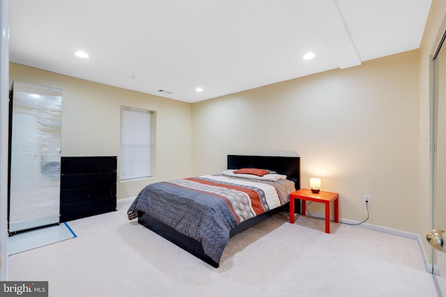 bedroom with carpet floors and recessed lighting