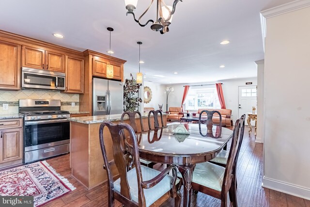 dining area featuring baseboards, recessed lighting, dark wood-style floors, and an inviting chandelier