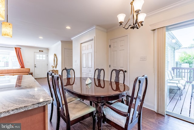 dining room with dark wood-style flooring, crown molding, baseboards, a notable chandelier, and recessed lighting