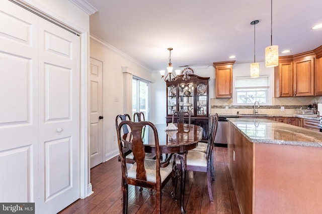dining space with crown molding, recessed lighting, dark wood finished floors, and a chandelier